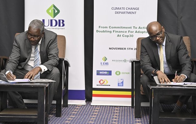 Dr.-Alfred-Okot-Okidi-L-PS-Ministry-of-Water-and-Environment-and-Denis-Ochieng-R-UDB-Director-Finance-and-Business-Operations-signing-the-MoU