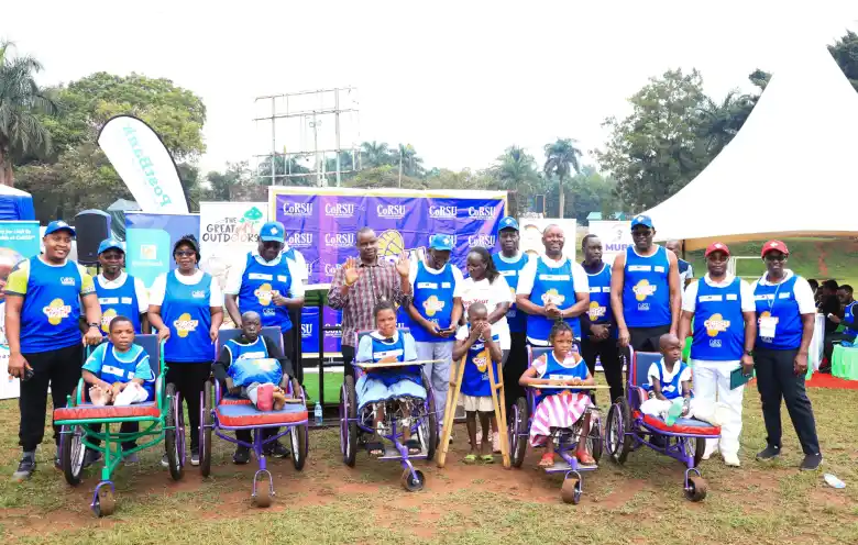 Hon.-Dr.-Balaam-Barugahara-Ateenyi-Cposes-for-a-photo-with-CoRSU-staff-and-children-with-disabilities