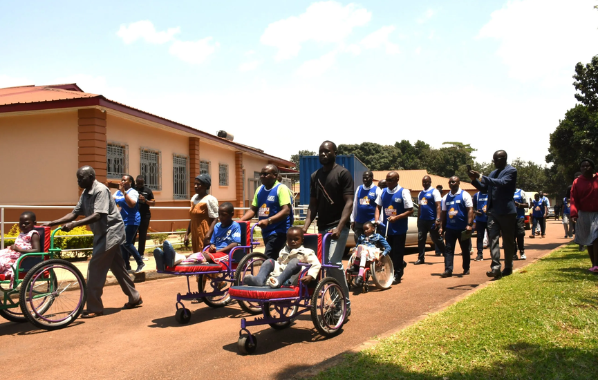 Some-of-the-hospital-staff-and-partners-walking-alongside-some-the-children-treated-at-the-CoRSU-Hospital-scaled