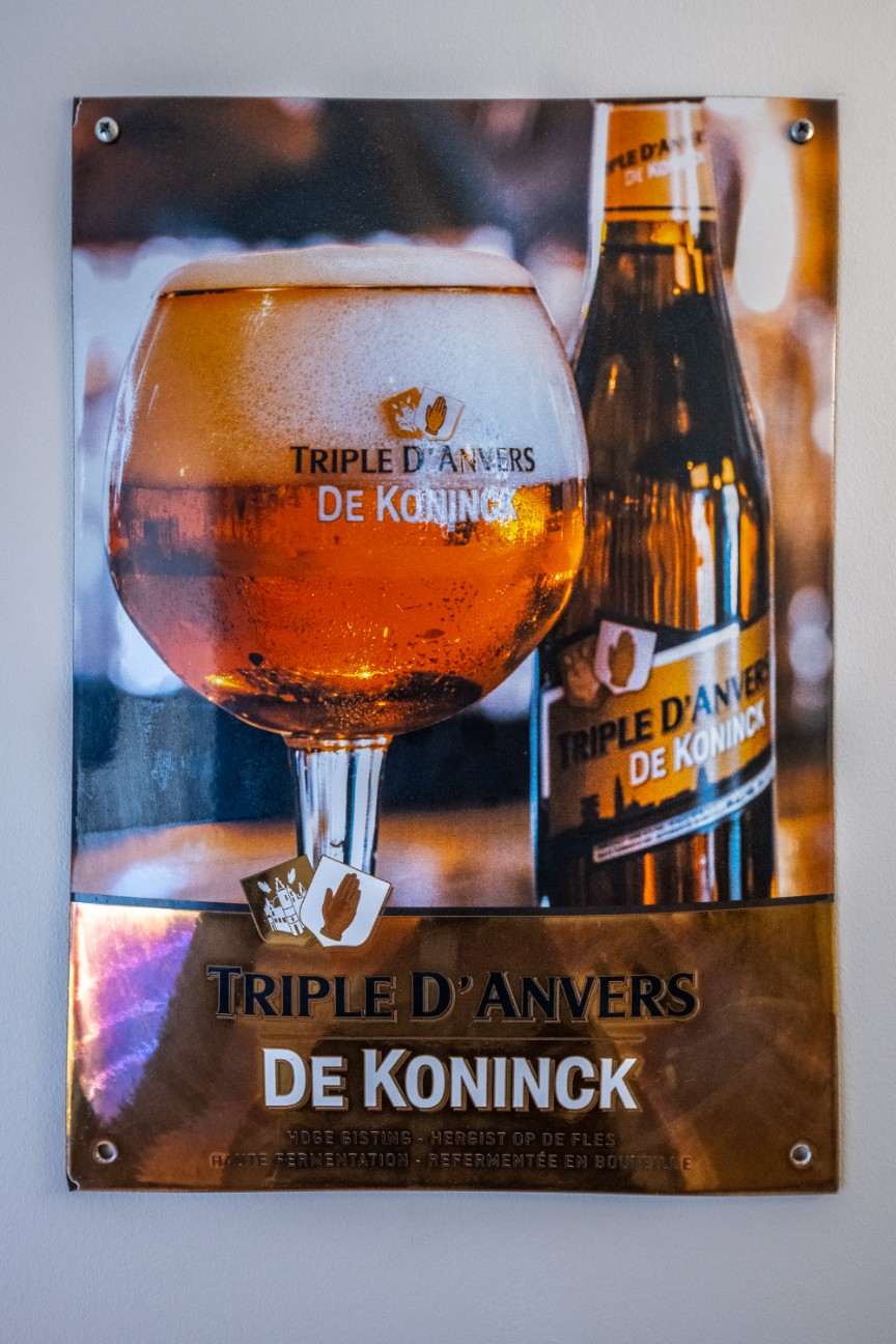De Koninck beer glass and bottle on display in the room