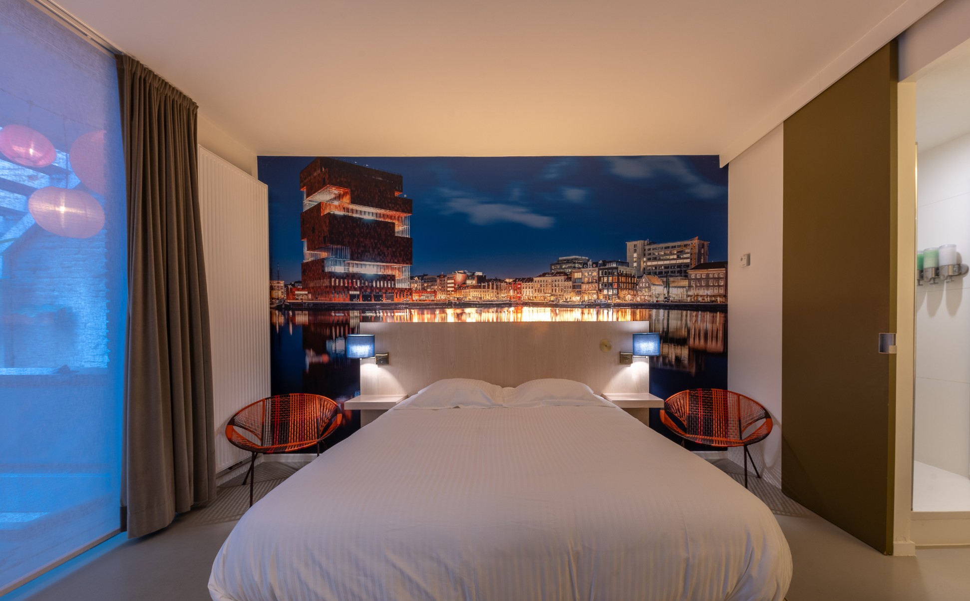 MAS Room with waterfront-view mural and contemporary furnishings