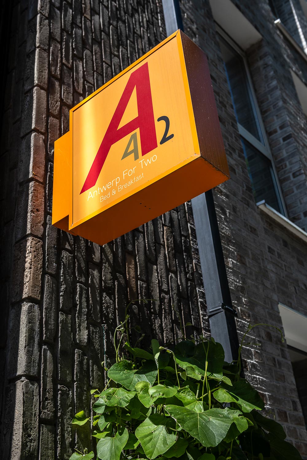 Yellow A2 sign at the entrance of the dark brick building