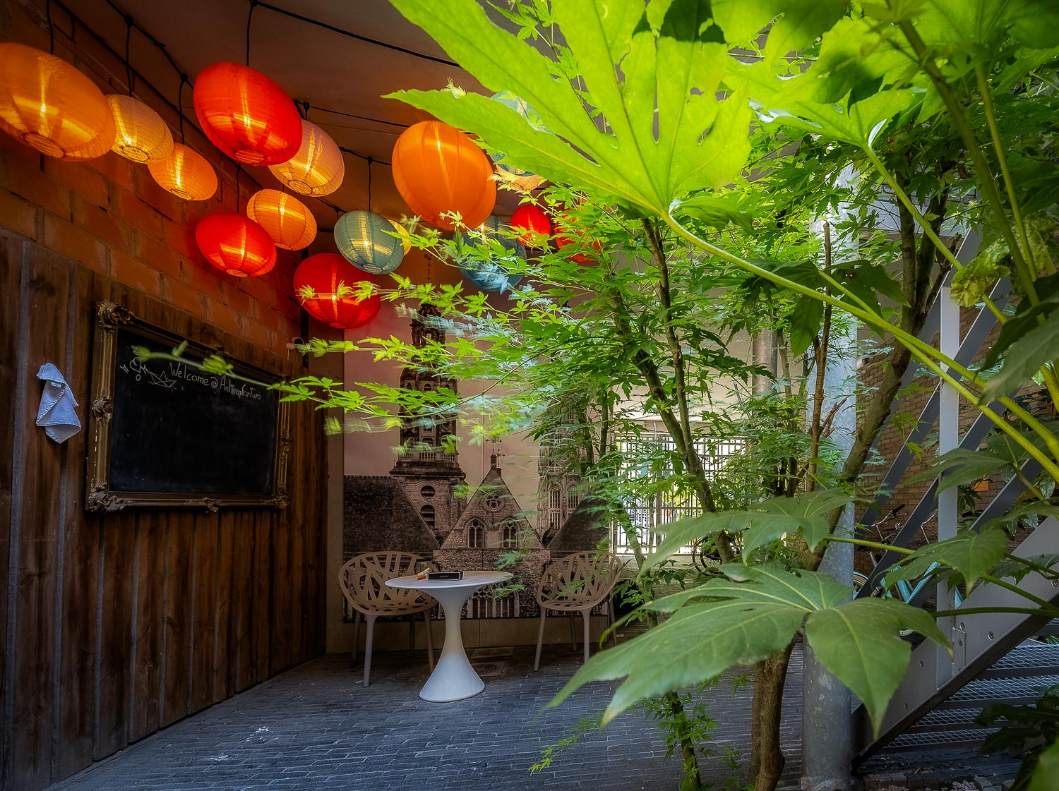 Intimate courtyard with red lanterns and climbing vines