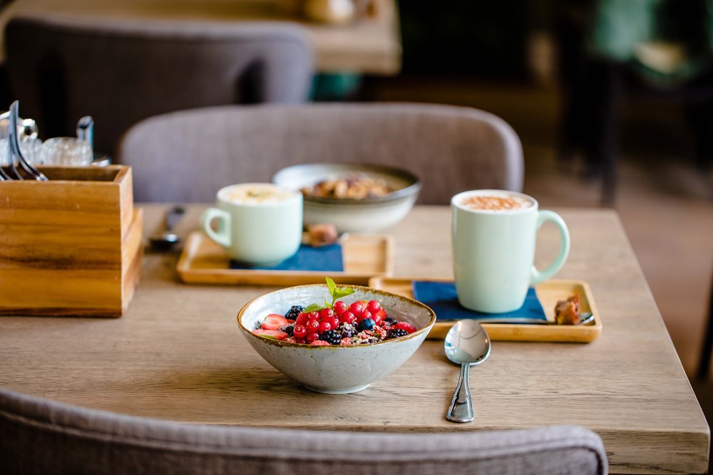 Breakfast with an acai bowl, coffee and pastries