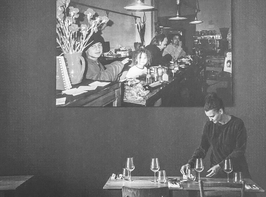 Bar counter with glasses and vintage artwork