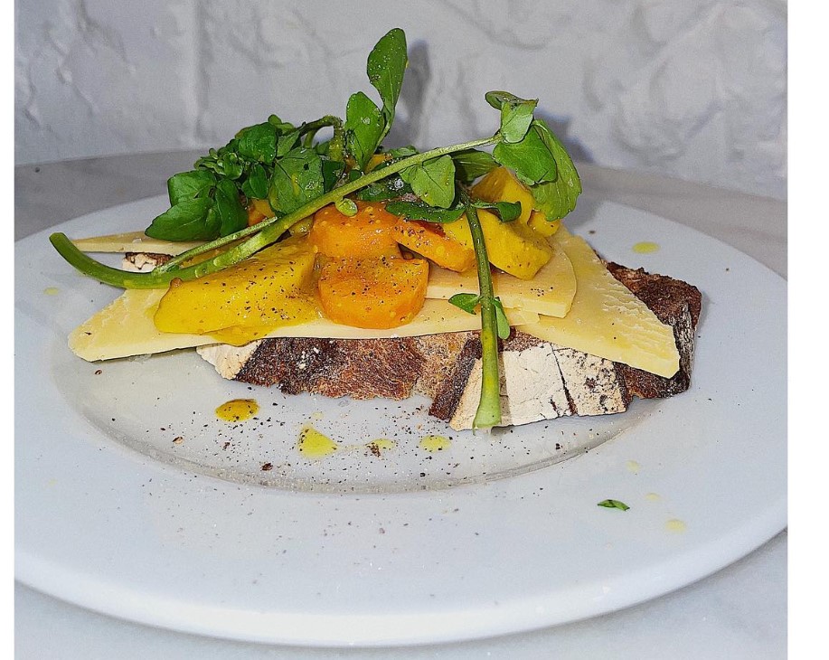 Plated fish dish with microgreens and asparagus