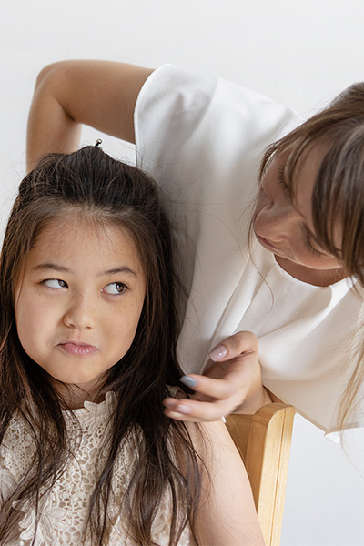 young girl looking at mother skeptically