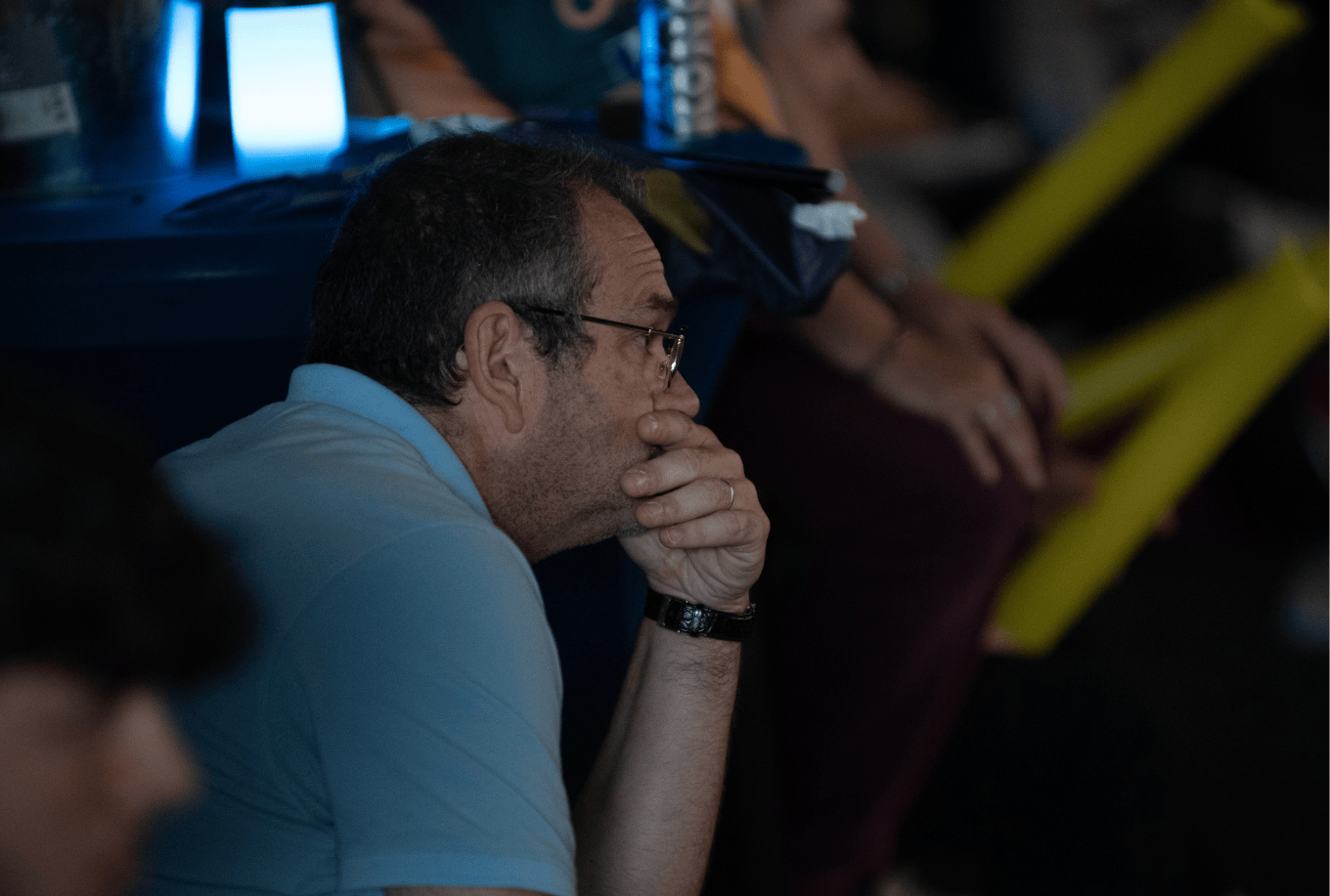 Bowling coach behind the lanes watching his athlete performing a bowling shot