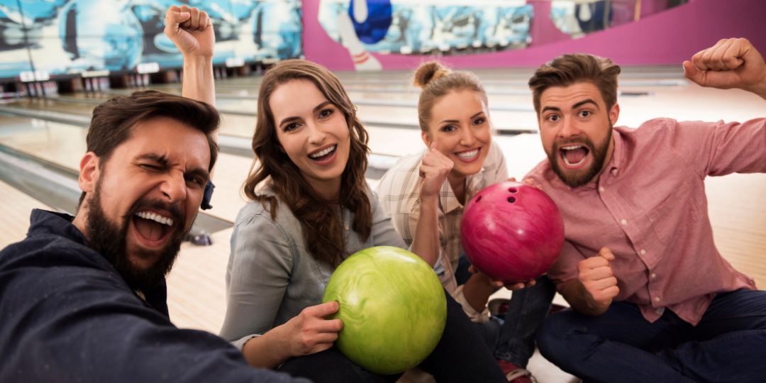 Four best friends play bowling in a bowling alley