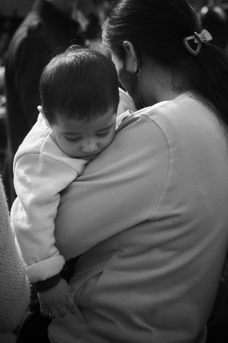 Distressed Mother carrying her Child · Free Stock Photo