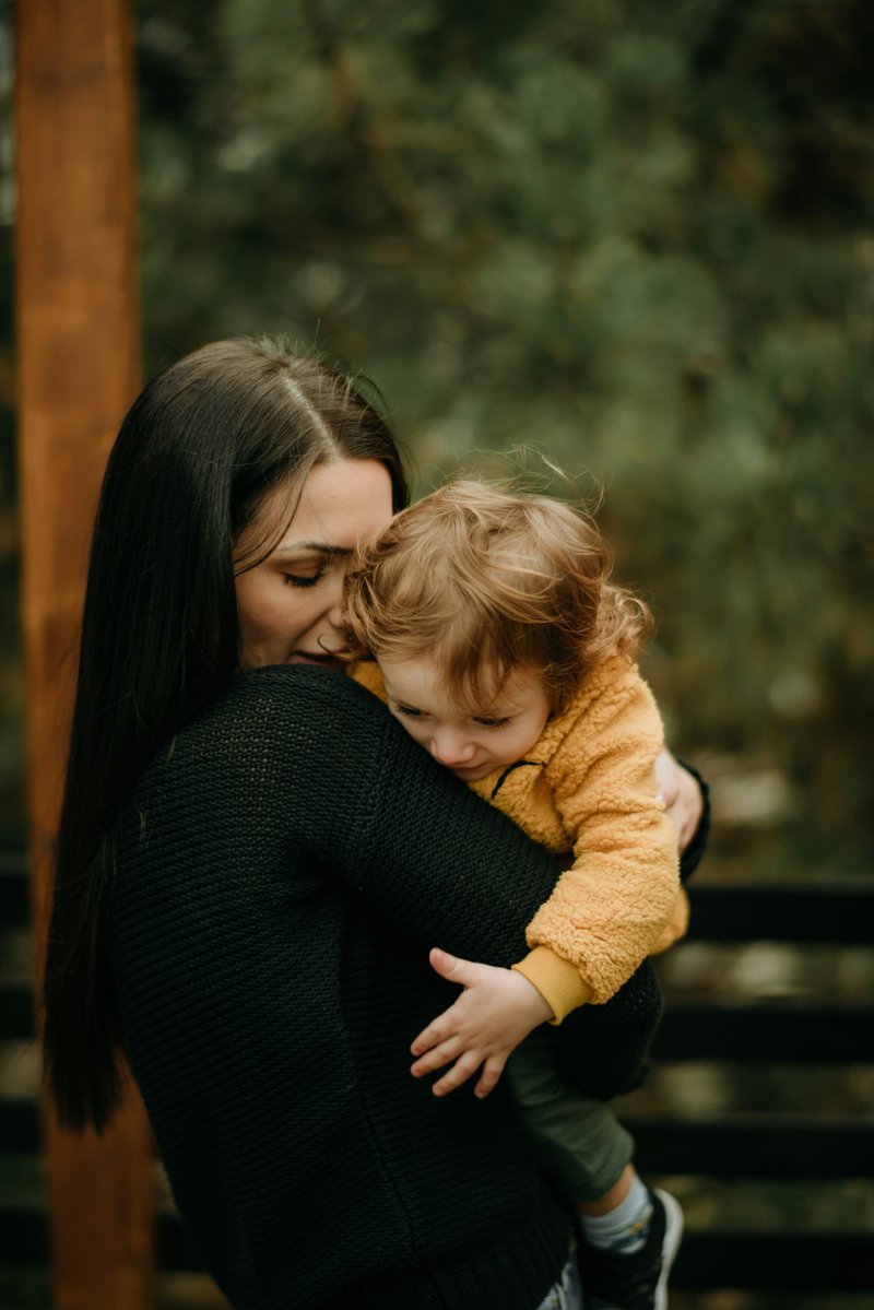A woman holding a small child in her arms photo – Free Photography Image on Unsplash