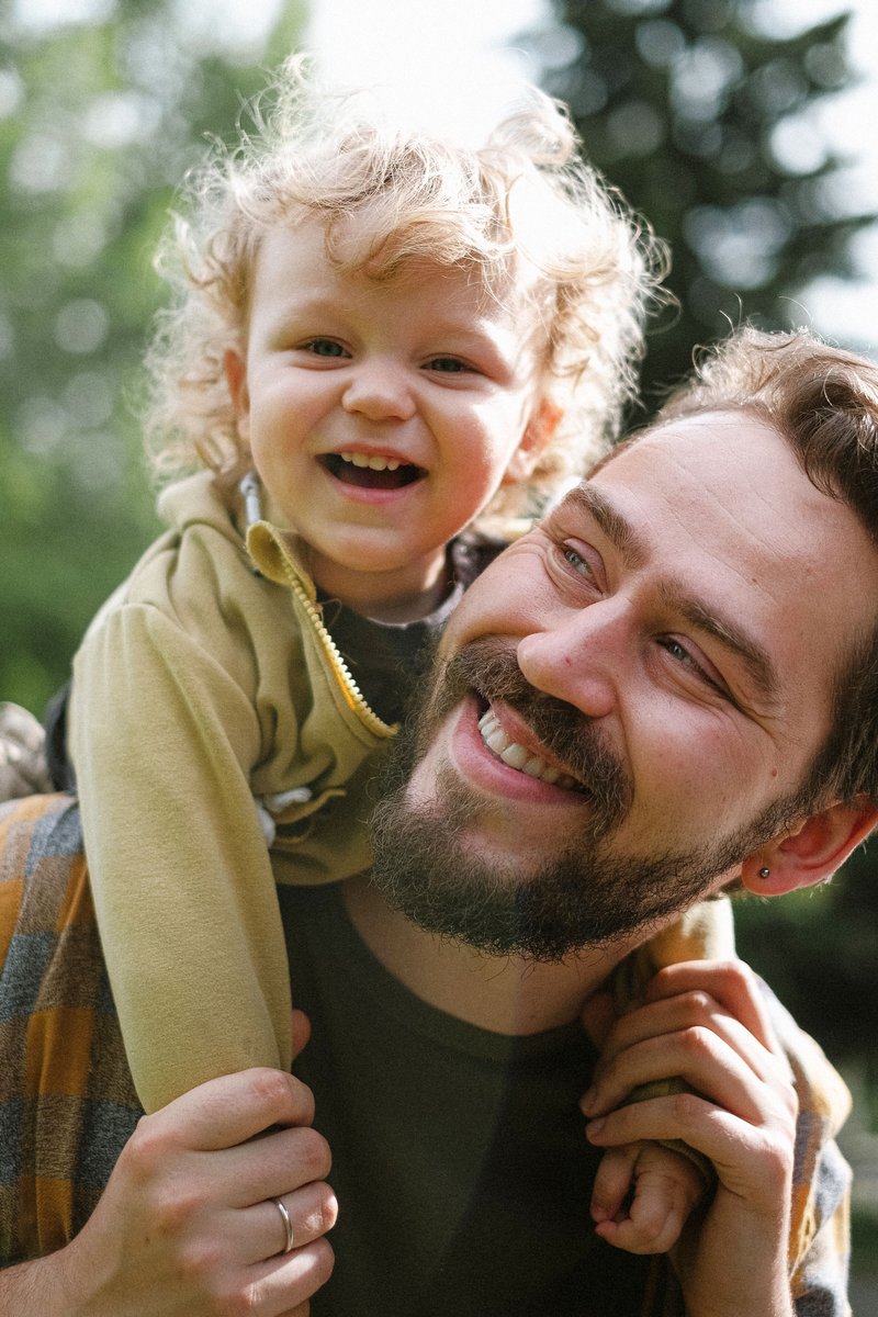 Close-up of a Father Holding His Baby and Smiling · Free Stock Photo