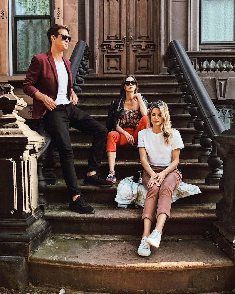 Two women sitting and man standing on stair photo – Free Woman Image on Unsplash