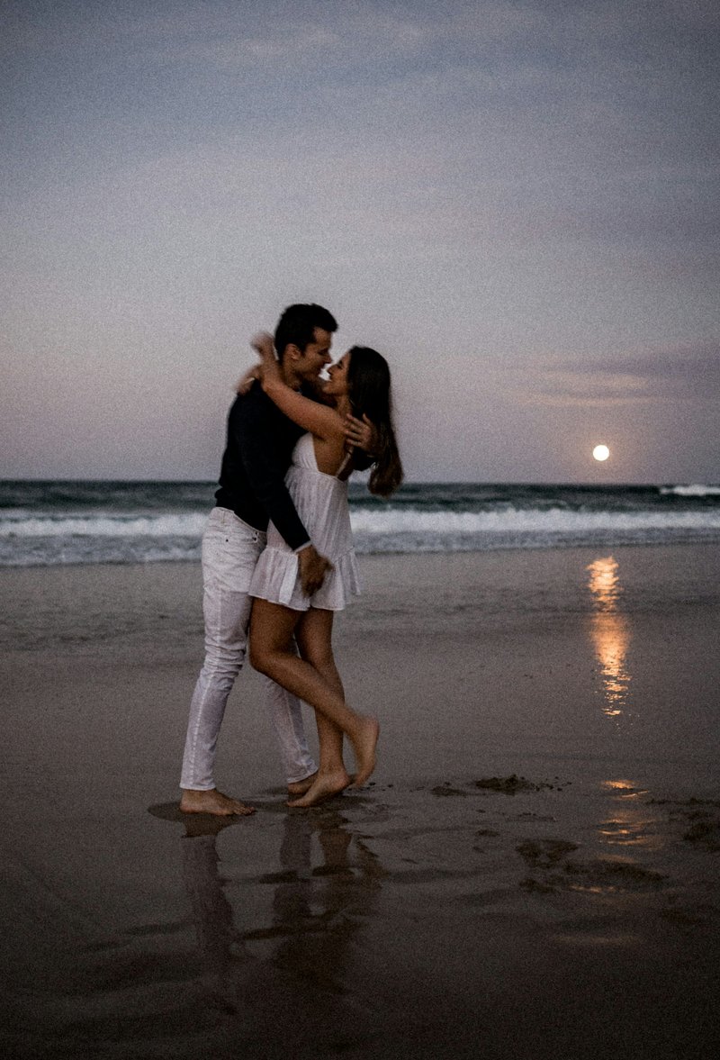 A man and a woman hugging on the beach photo – Free Beach ...