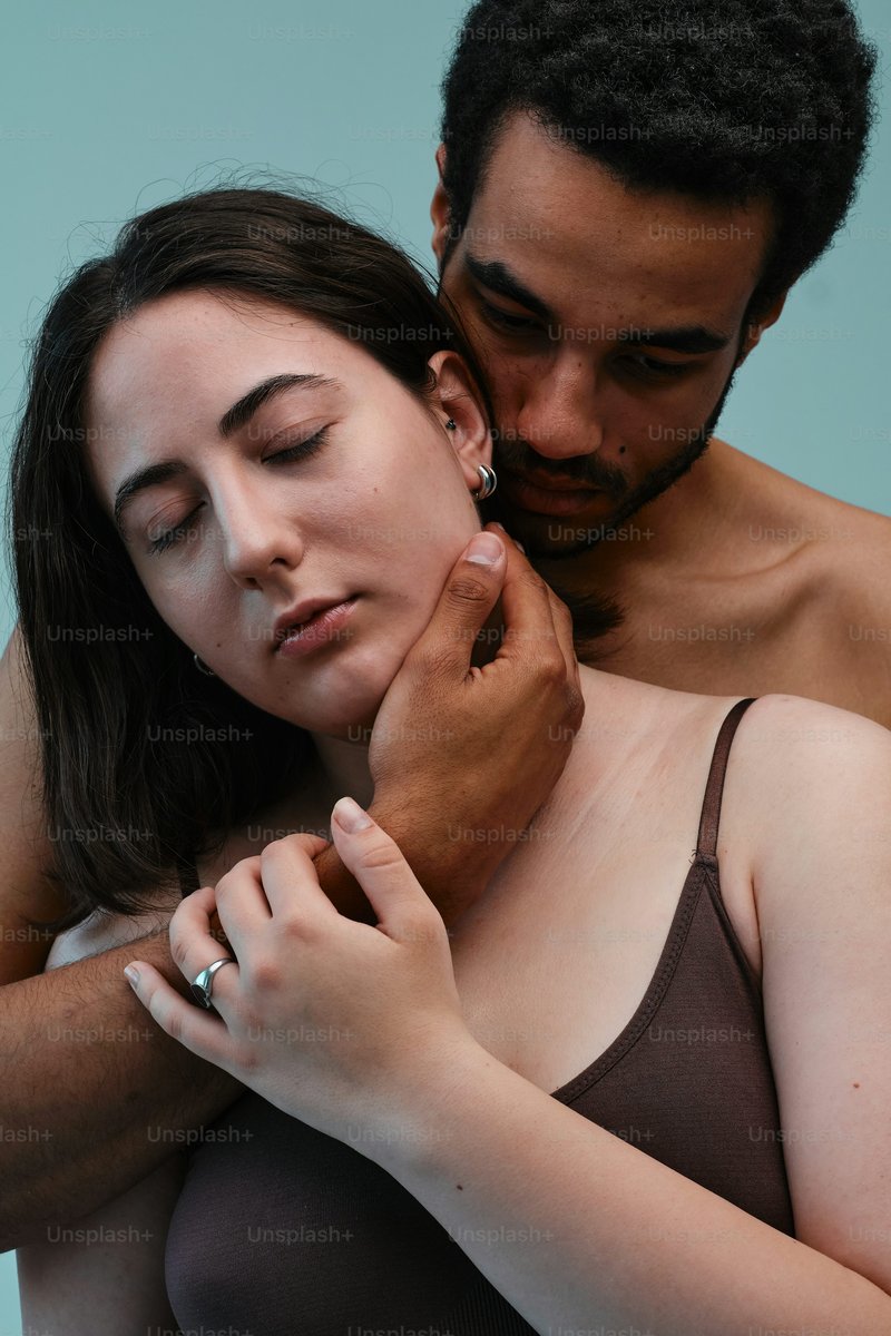 A woman in a bra touching the chest of a man photo – Couple ...