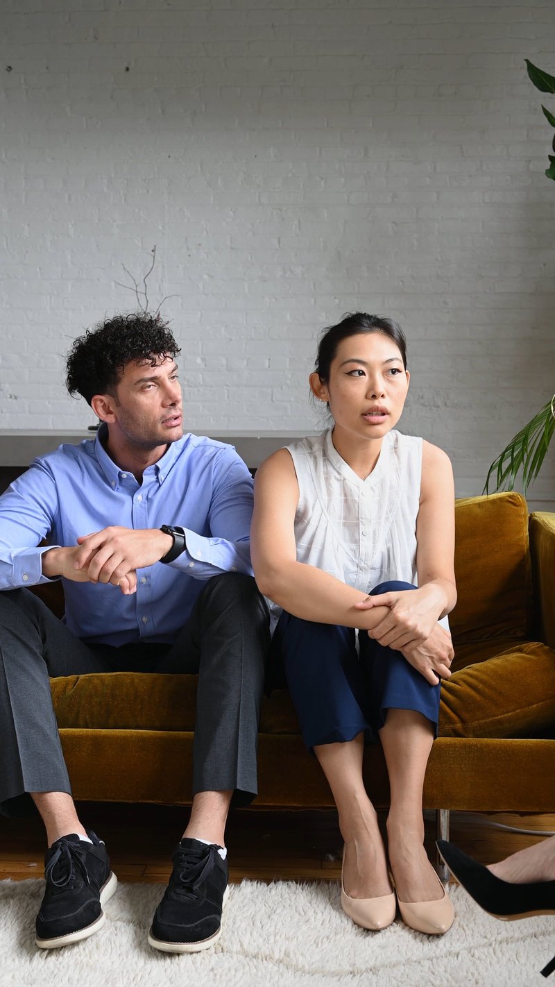 Couple Fighting while Sitting in a Sofa