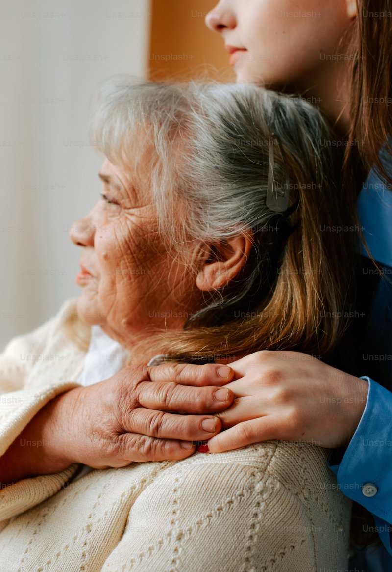 Older woman comforting younger person on sofa photo – Family ...
