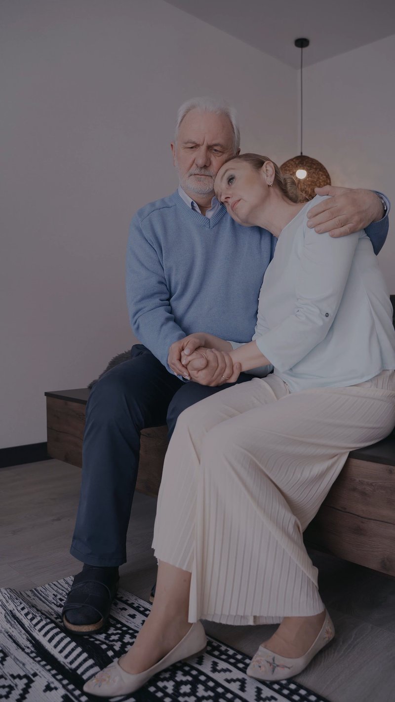 A Man Patting the Shoulder of a Woman