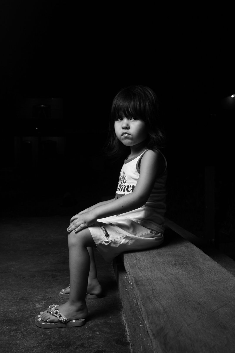 Black and White Photo of a Little Girl Sitting on a Bench in ...