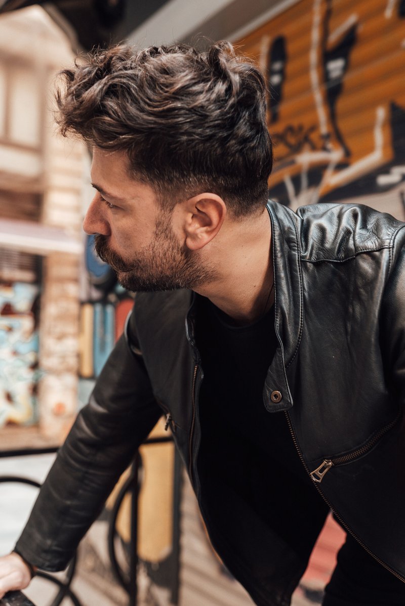 Serious man standing on city street · Free Stock Photo