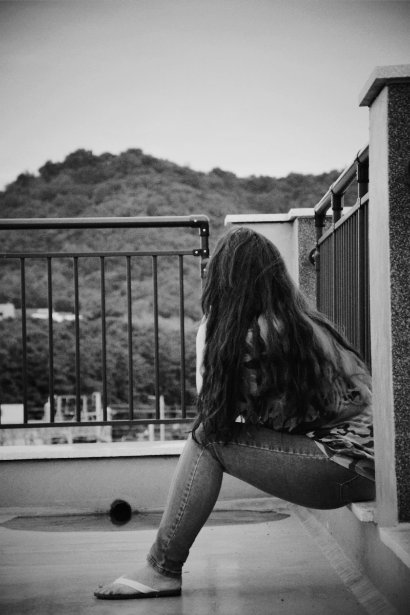 Woman Sitting Alone on Balcony · Free Stock Photo