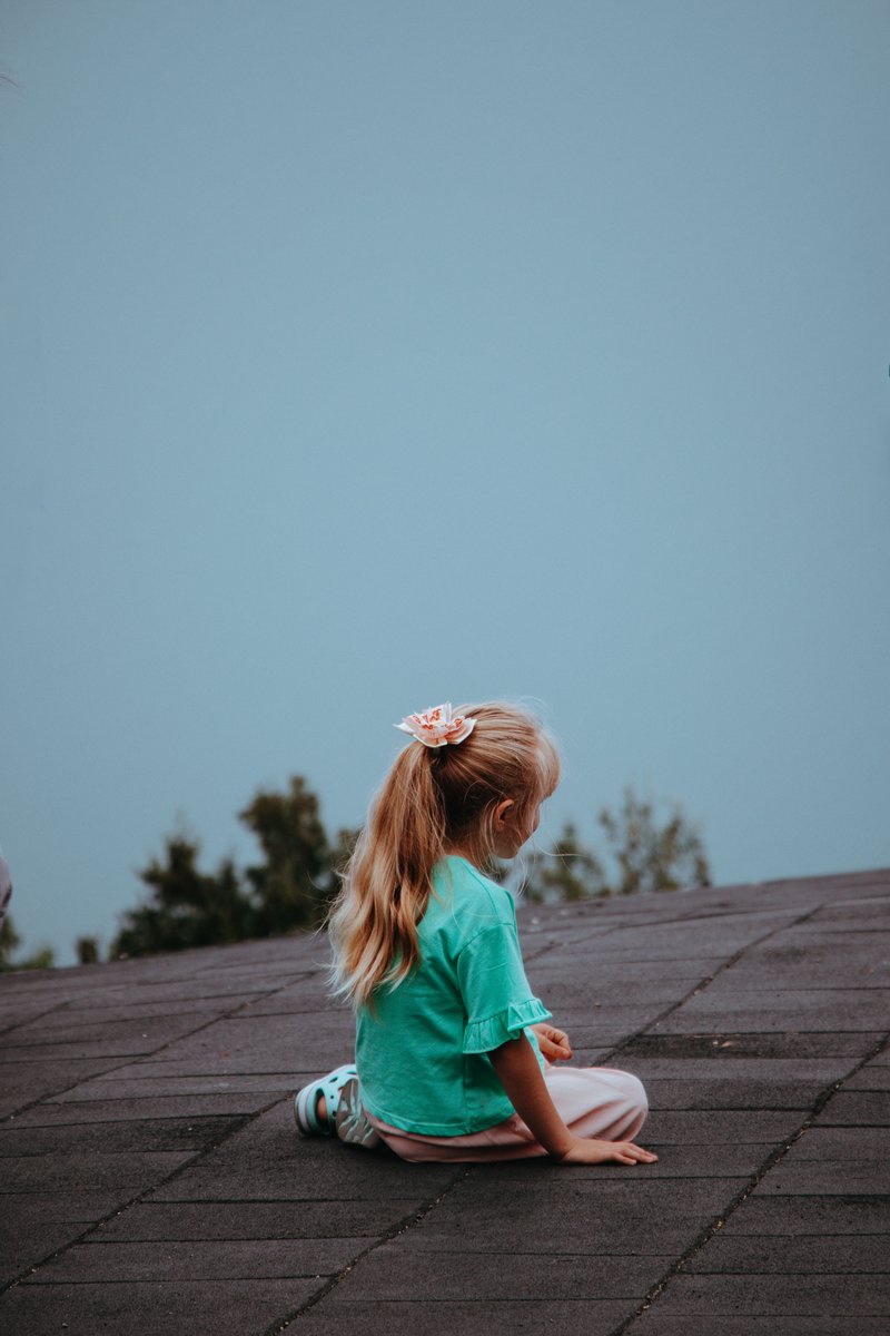A Girl Sitting Outdoors · Free Stock Photo