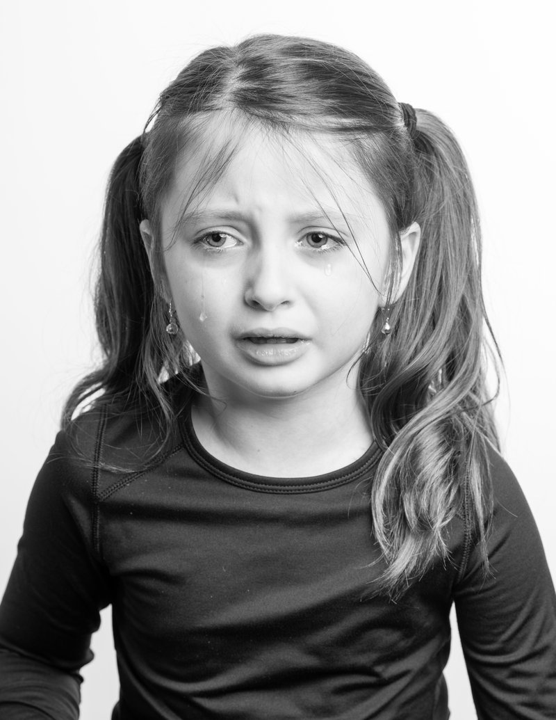 Little girl crying against white background · Free Stock Photo