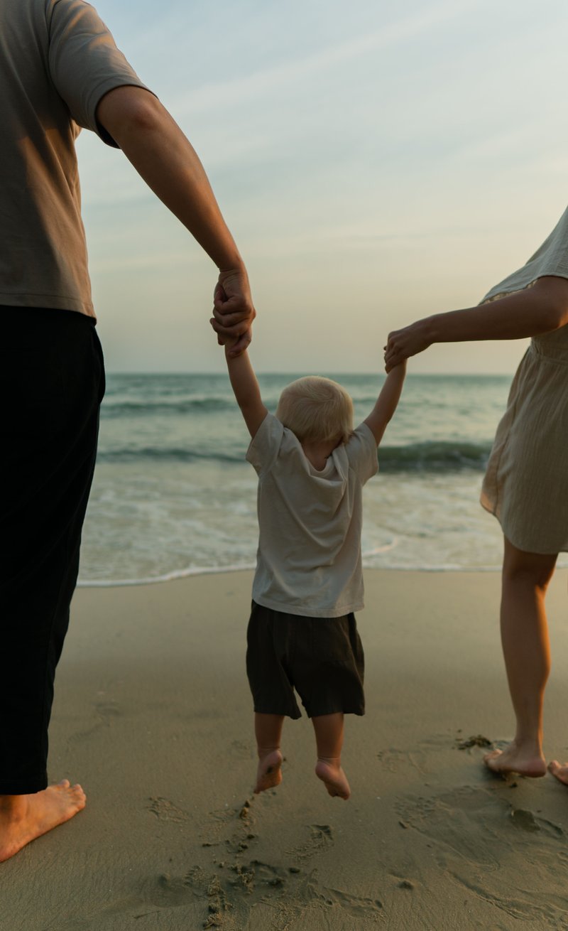 Family Walk Holding Hands on the Beach · Free Stock Photo