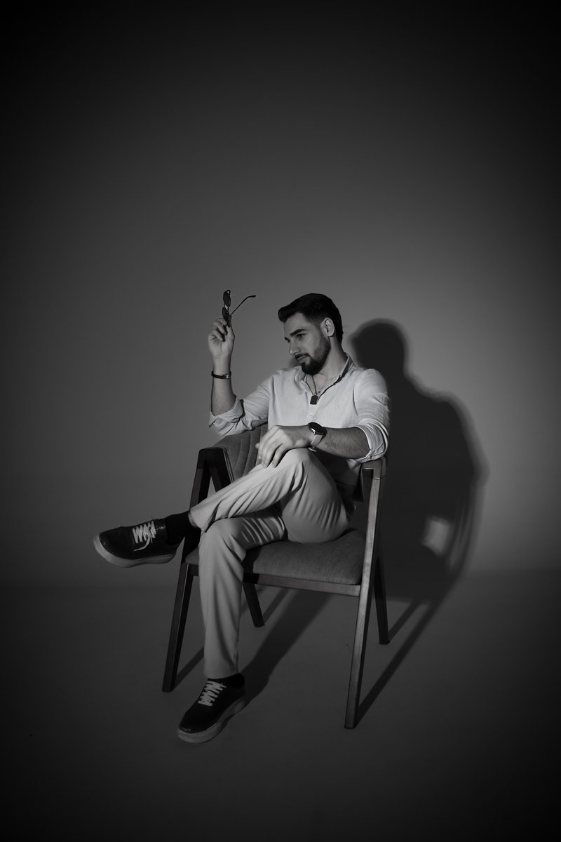 Black and White Portrait of Stylish Man Seated · Free Stock Photo
