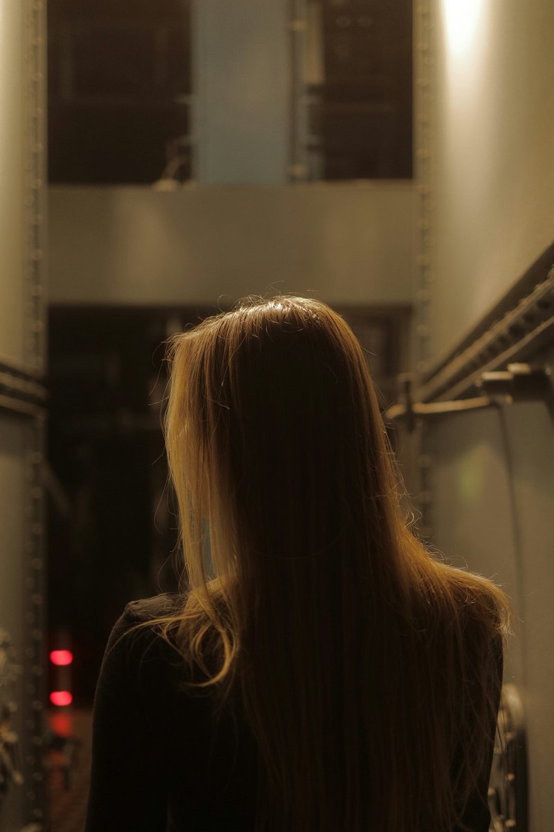 A woman with long blonde hair standing in a hallway - Free Photo on Unsplash