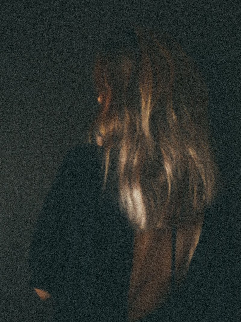 Dark Abstract Photograph of a Woman with Blond Hair · Free Stock Photo