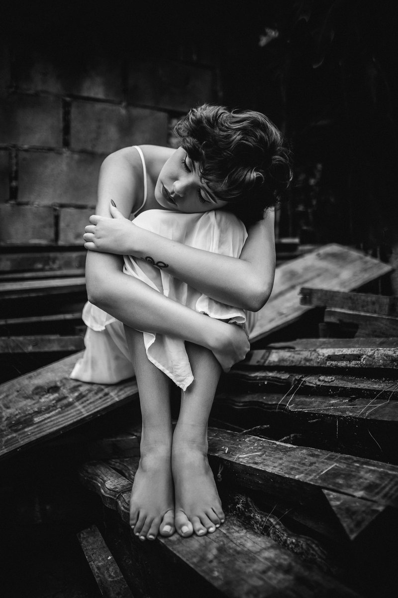 Sad Woman in Dress Sitting on Wooden Plank · Free Stock Photo