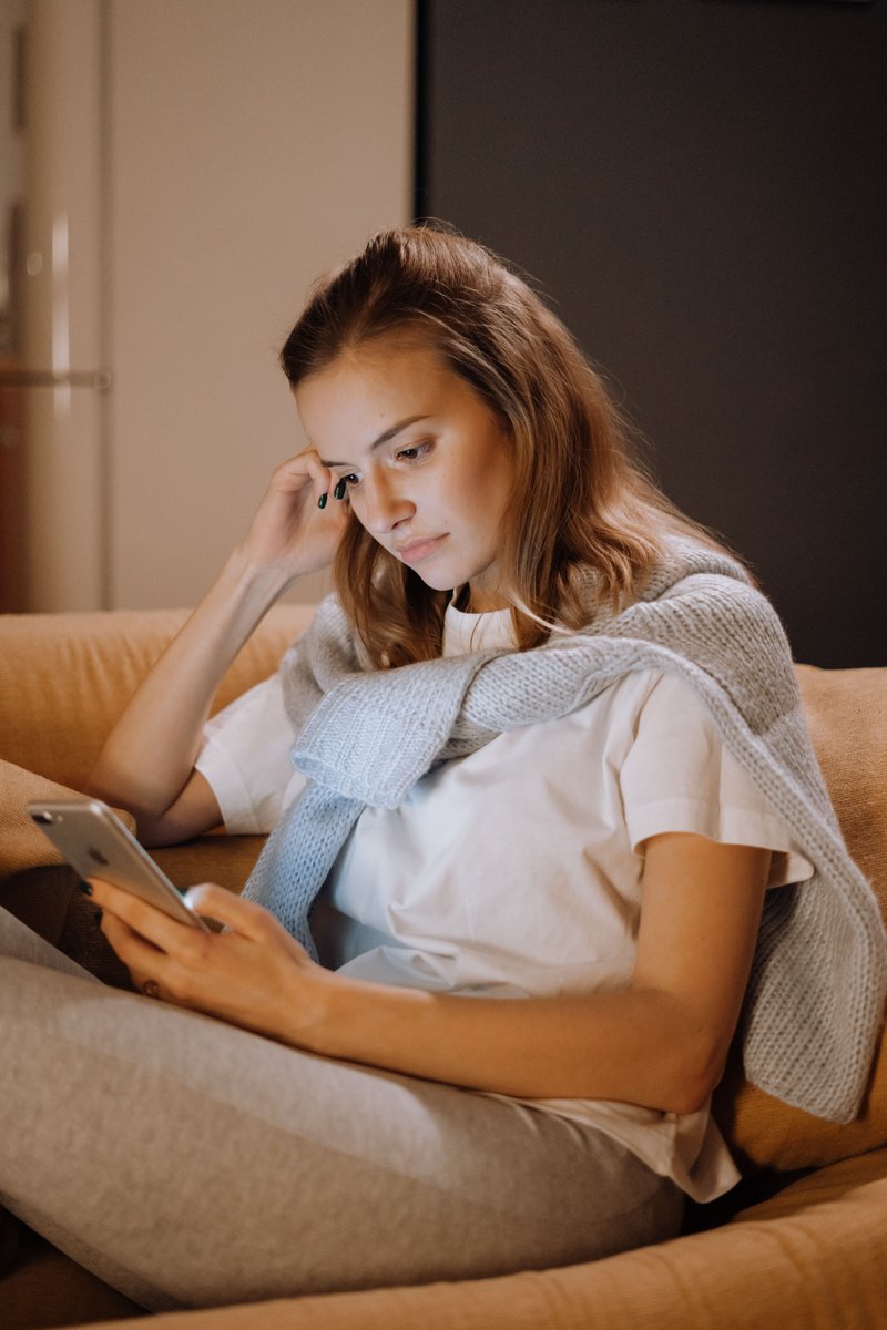 A Woman Crying While Looking at Her Phone · Free Stock Photo