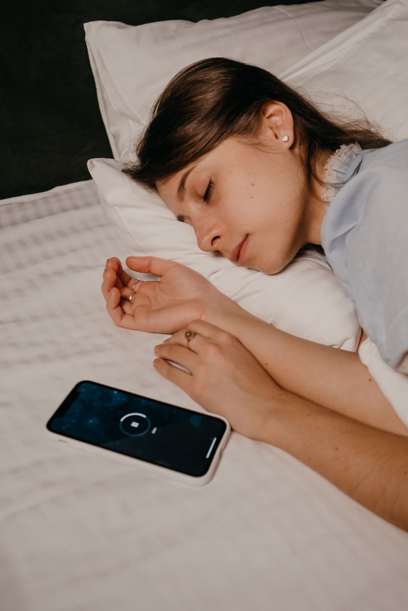 Phone beside an Asleep Woman · Free Stock Photo