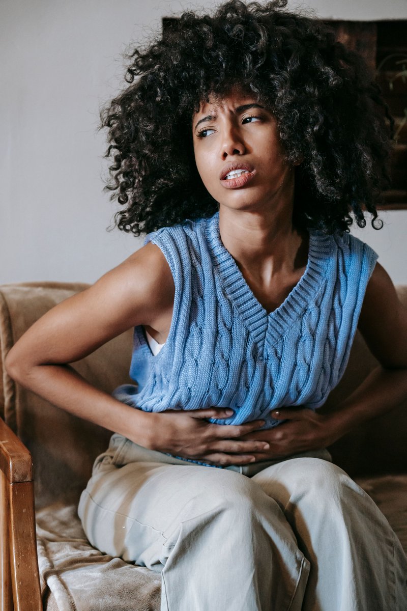 Woman Suffering from a Stomach Pain · Free Stock Photo