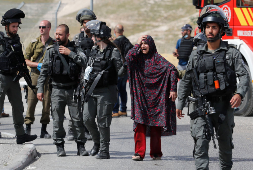 In Pictures| Israeli soldiers drag martyr's mother to see her son's blood before arresting her