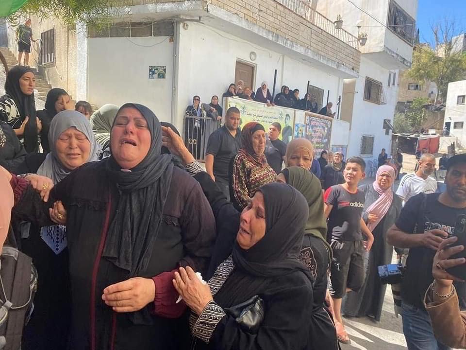 Palestinian mourners take part in funeral procession of youth killed by Israeli forces in Jenin