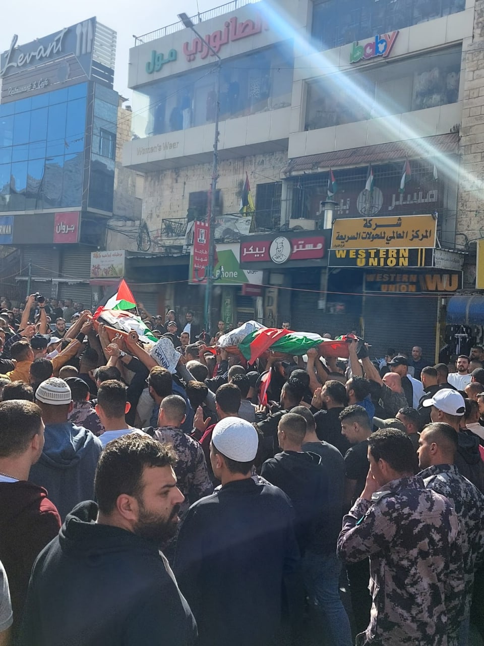Mourners take part in funeral procession of two Palestinians killed by Israeli forces in Nablus