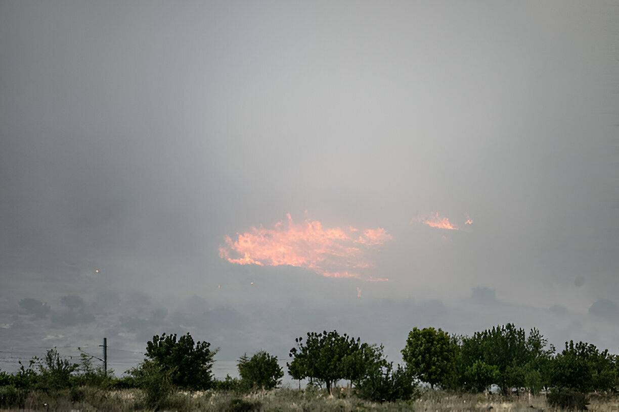 Wildfires swept through the hills of the occupied Palestinian capital city of Jerusalem on Wednesday, choking the skies with smoke and forcing thousands of Israeli settlers to evacuate.