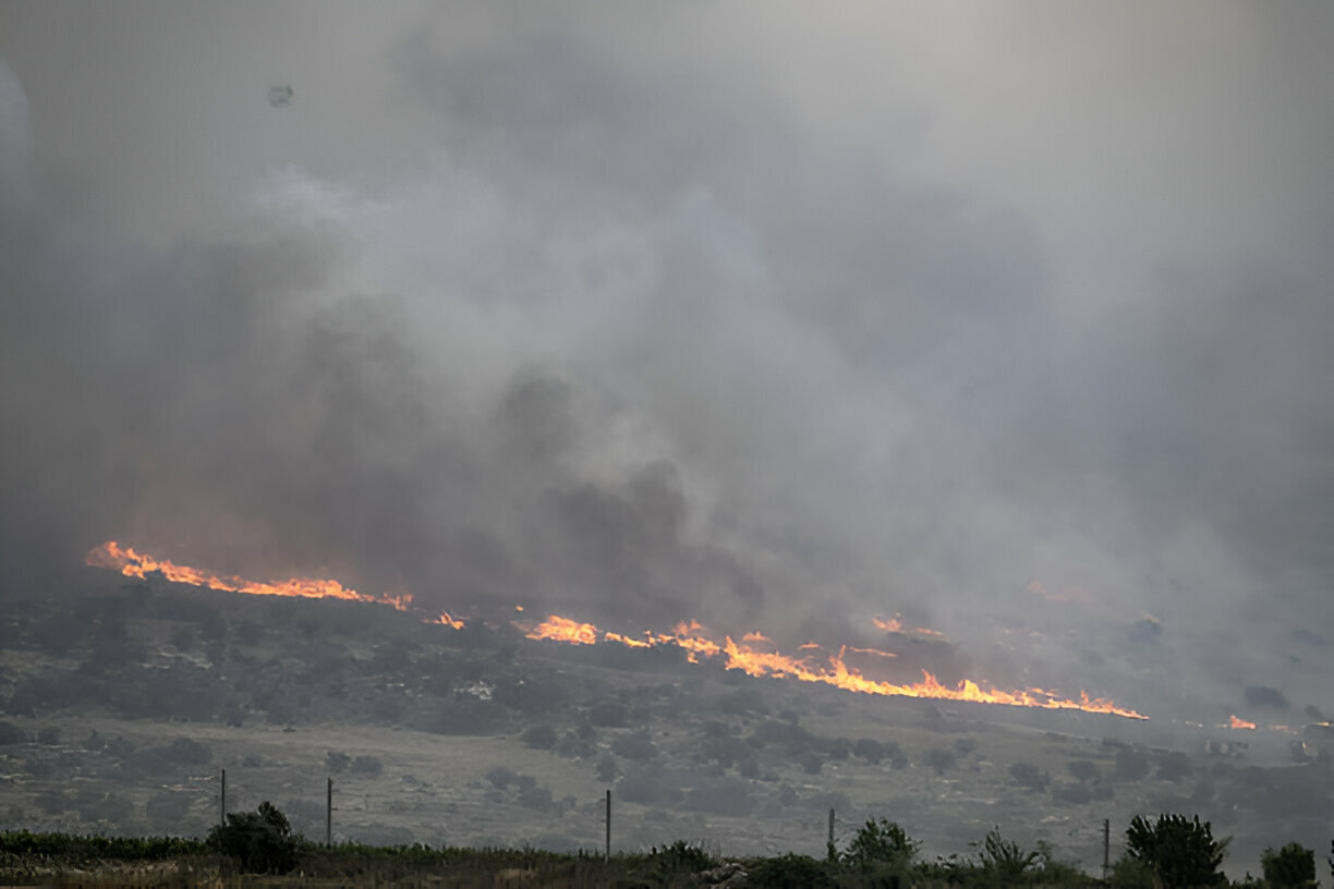 Wildfires swept through the hills of the occupied Palestinian capital city of Jerusalem on Wednesday, choking the skies with smoke and forcing thousands of Israeli settlers to evacuate.