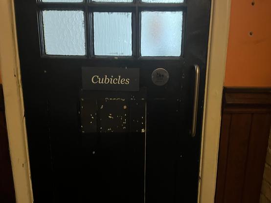 door labelled “cubicles” with a baby change symbol