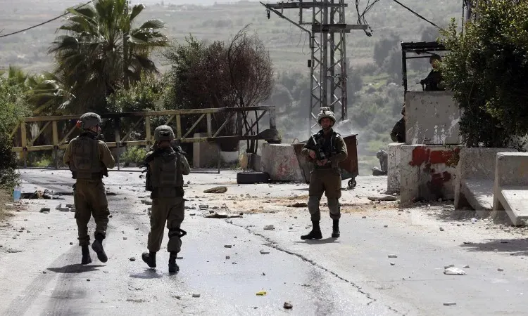 Israeli Forces Raid Kafr Malik as Settlers Damage Crops