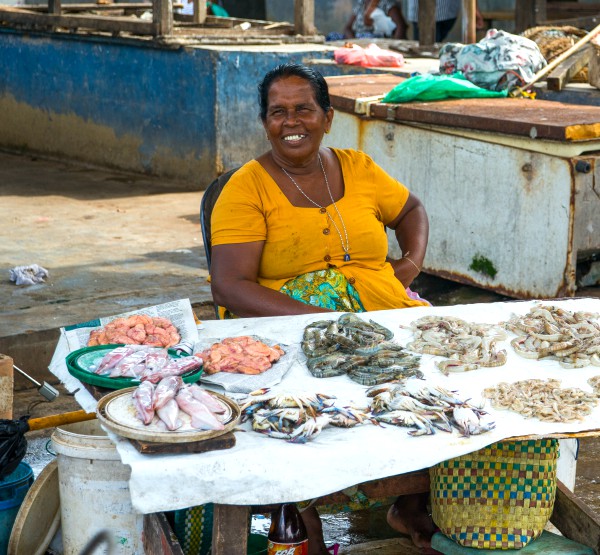 goedlachse vrouw achter viskraam Negombo fish market