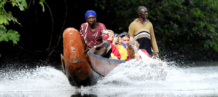 Mensen maken een tocht met een traditionele korjaalboot op de Kabalebo-rivier in Suriname