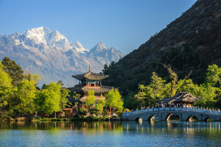 uitzicht op oude stadje Lijiang met pagode en besneeuwde bergtoppen