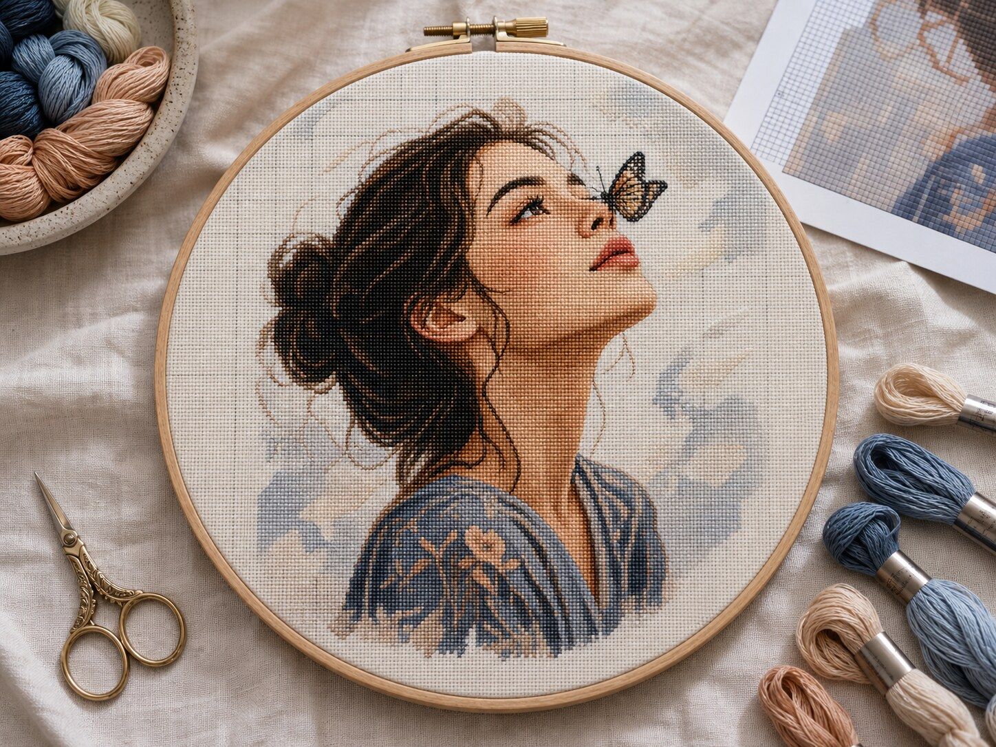 Butterfly Daydream Portrait cross-stitch pattern held in a hoop
