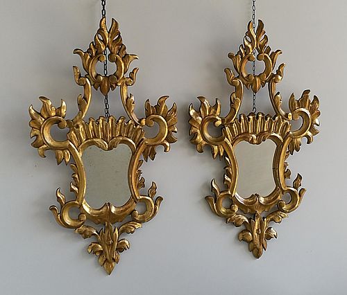 Pair of carved and gilded fan mirrors