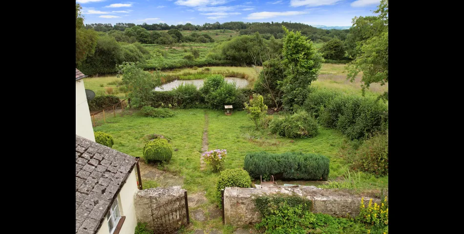 Two bedroom semi-detached stone cottage sitting within approximately two acres of grounds
