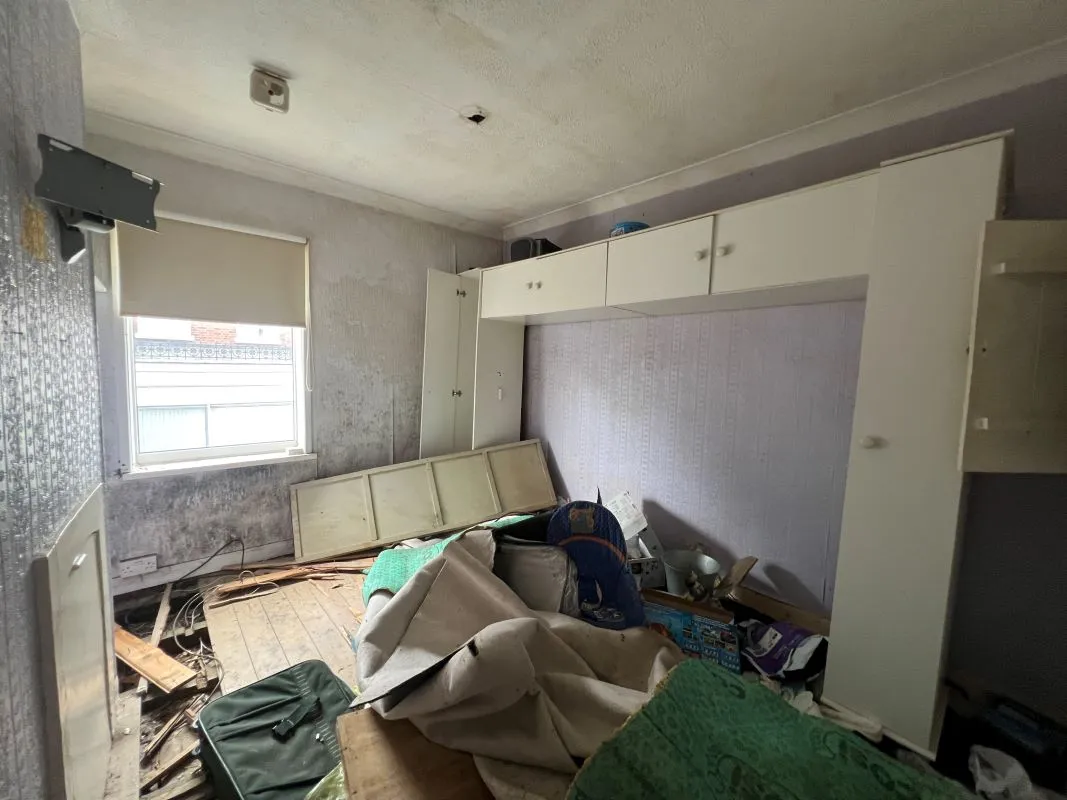 A vacant freehold three bedroom mid terraced property