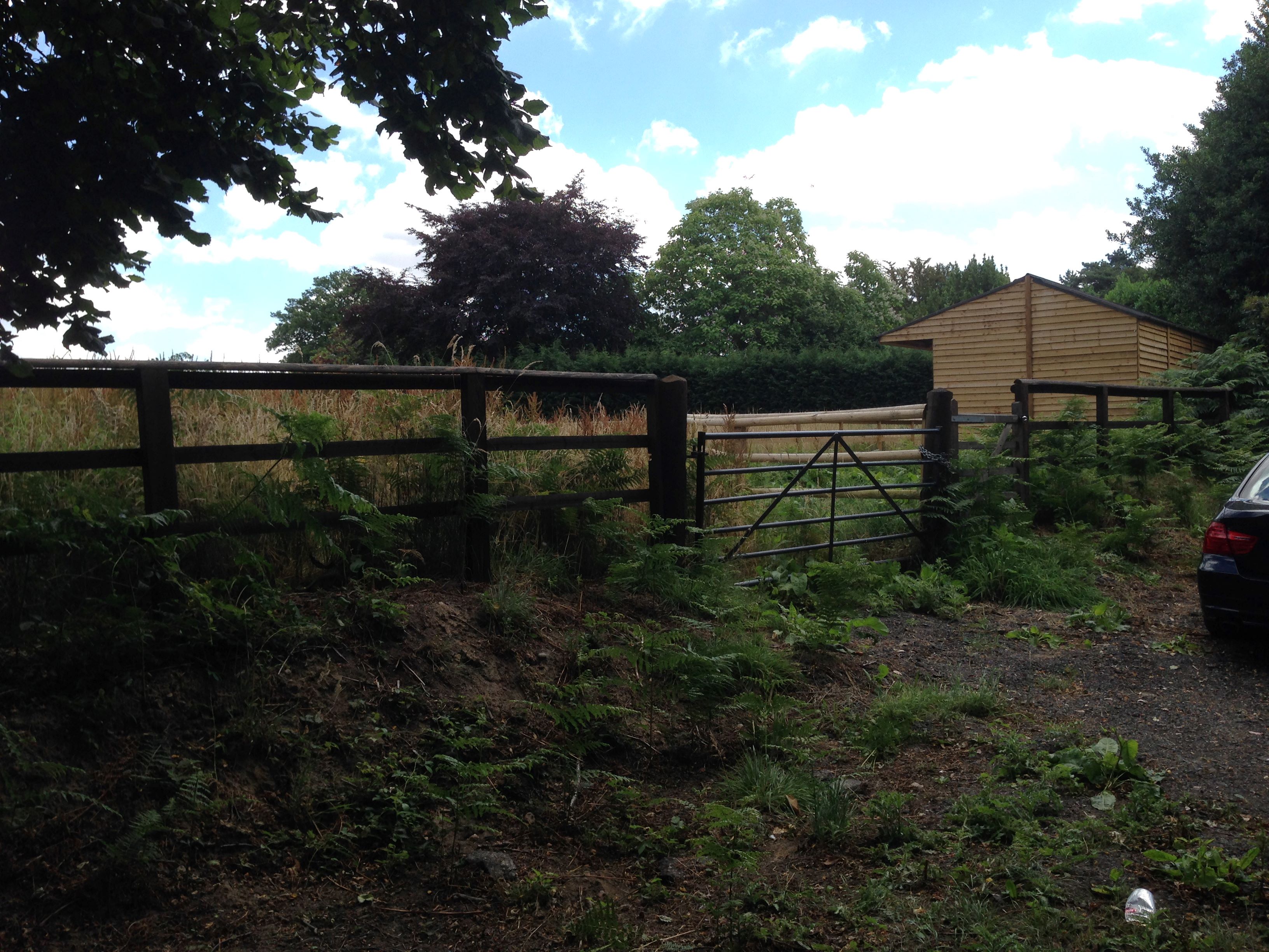 A paddock of approximately 0.38 acre enclosed by wooden fencing with a movable modern wooden stable block suitable for two horses plus a tack room.